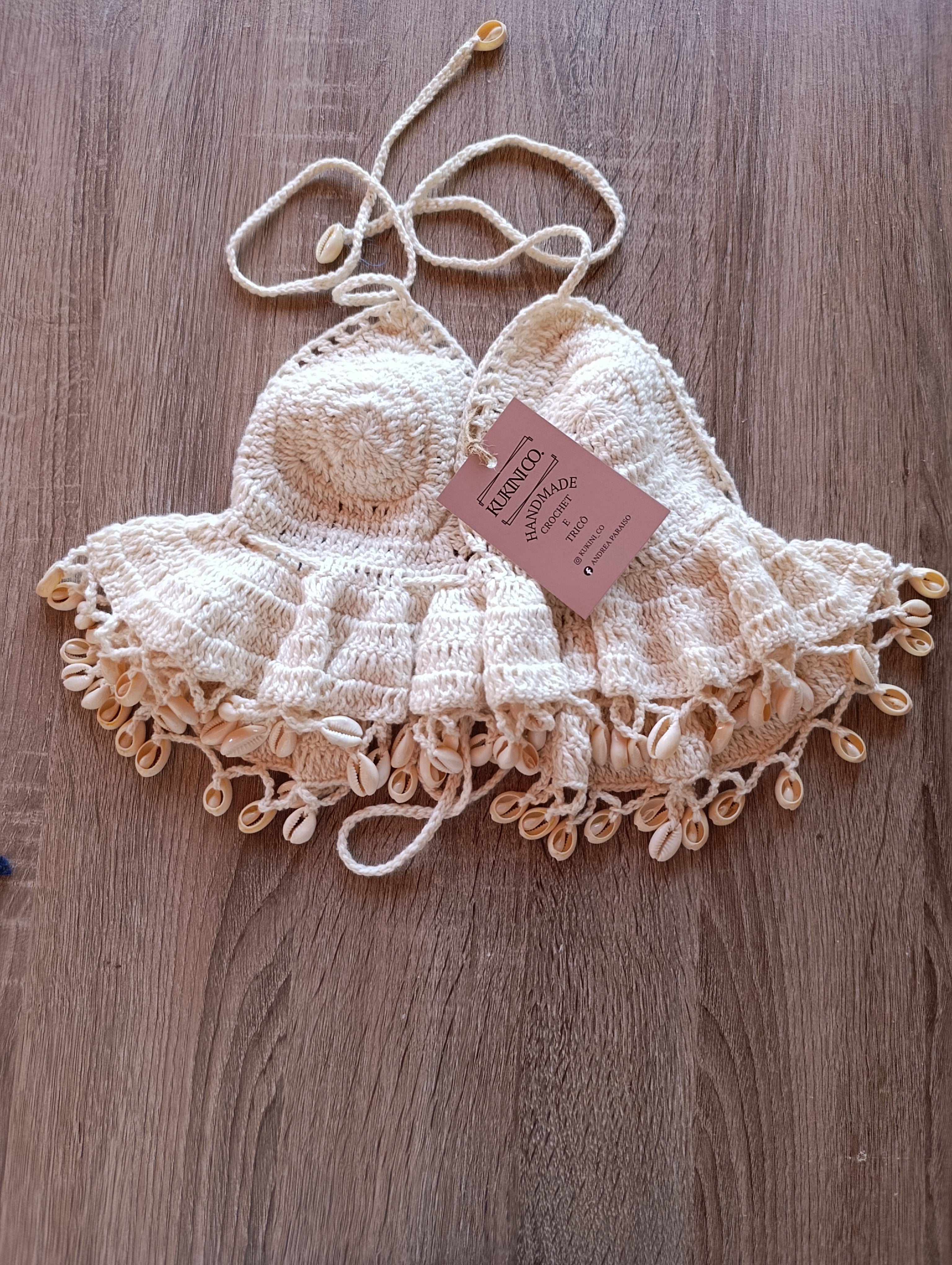 Top crochet halter creme com conchinhas da Kukini Co., estilo confortável e delicado, com detalhes de conchinhas na peça.