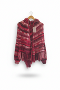 Casaco poncho de crochê com capuz em tons vermelhos, feito pela Kukini Co., mostrando detalhes do tecido e design aconchegante.